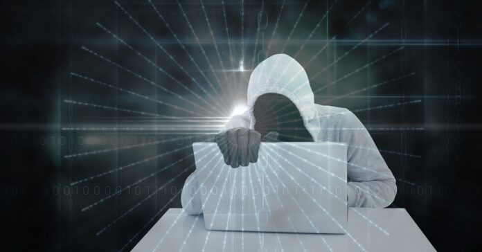 Digital composite image of hacker using laptop